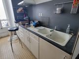a kitchen with a sink, stove, and refrigerator in it