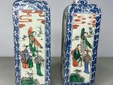 pair of chinese blue and white vases with figures on them