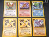 four pokemon cards sitting on top of each other on a table