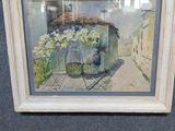 tableau représentant une scène de rue avec un panier de fleurs, dans un cadre doré