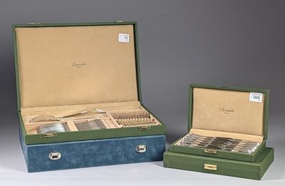 two boxes with silverware in them sitting on a table