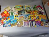 many children ' s books in a box on the table