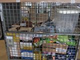 a metal cart with many items in it in a warehouse