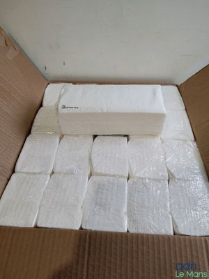 a box full of toilet paper that is in the middle of the floor