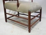 a wooden bench with a beige upholstered seat
