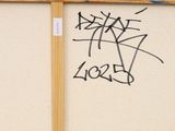 graffiti on the wall of a building with a stop sign in front of it