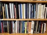 a book shelf with many books on it in a room