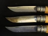 three knives that are sitting next to each other on a table