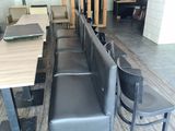 une longue table avec des chaises et un banc au milieu de la pièce