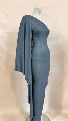 a woman in a grey dress standing on a white mannequin