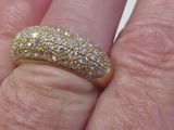 une bague en or et diamants au doigt d'une personne