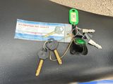 a bunch of keys sitting on the seat of a motorcycle