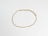 une image d'un bracelet en or sur une surface blanche