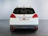 the rear end of a white car parked in a garage
