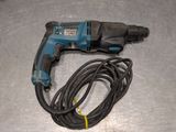 a cord that is connected to a drill on a table