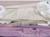 a purple suitcase with a white cloth inside of it