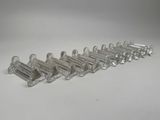 six clear glass toothbrush holders lined up on a white surface