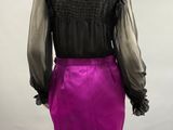 a woman ' s purple skirt and black blouse on a mannequin mannequin mannequin mannequin mannequin mannequin mannequin