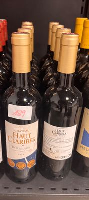 many bottles of wine sitting on a shelf in a store