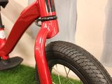 a red bike that is sitting on the grass