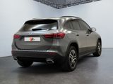the rear view of a grey mercedes suv parked in a garage