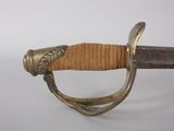 an image of a close up of a sword on a white surface