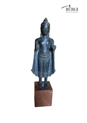 an image of a statue of a person standing on a block
