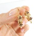 a person holding a pair of earrings in their hand