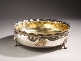 an image of a silver bowl on a stand on a white surface