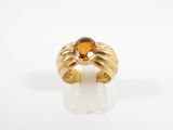 a close up of a gold ring with a citrine stone