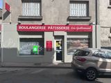 a car parked in front of a building with a sign that says boulangerie patisserierie