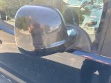 reflection of a man taking a picture of himself in the side view mirror of a car