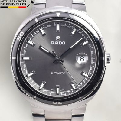 a close up of a watch on a white surface