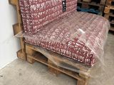 a couch made out of pallets in a warehouse