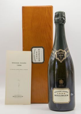the bottle of champagne is next to a wooden box and a card