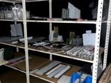 a room with a lot of shelves and bins on it