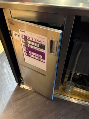 a stainless steel dishwasher that is open on the counter