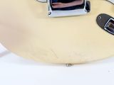 a close up of an electric guitar with a white body