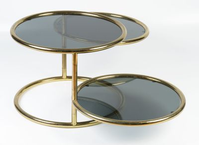 two tiered glass and brass side tables with mirrors on them
