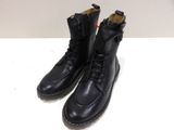 men ' s black leather boots on a white surface