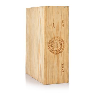a wooden box with a wine bottle inside of it on a white surface