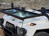 a large white truck with a glass top on the back of it