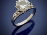 an engagement ring with a round brilliant cut diamond set in 18k white gold