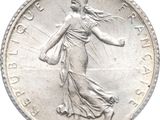 an image of a coin with a woman holding a bag