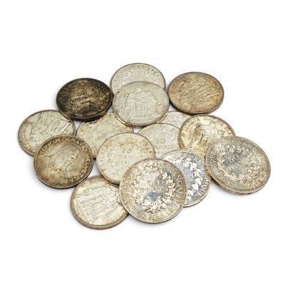 a pile of old coins on a white surface