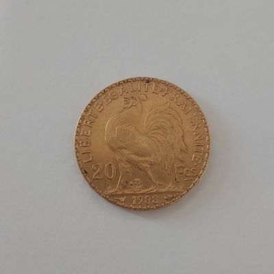 une pièce d'or sur laquelle est représenté un coq