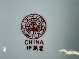 a white plate with a red and black design on it