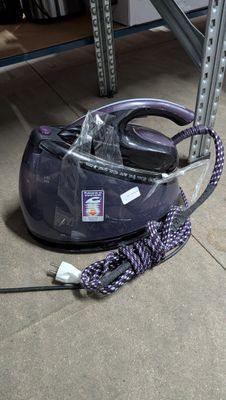 a vacuum that is sitting on the floor next to a bag