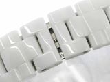 a close up of a white watch bracelet on a white surface