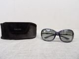 a pair of sunglasses sitting on a table next to a black case